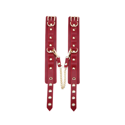 A set red Luxe Bondage cuffs opened up and chained.
