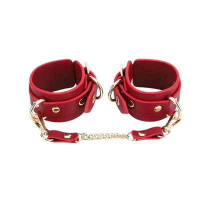 A set red Luxe Bondage cuffs chained together.