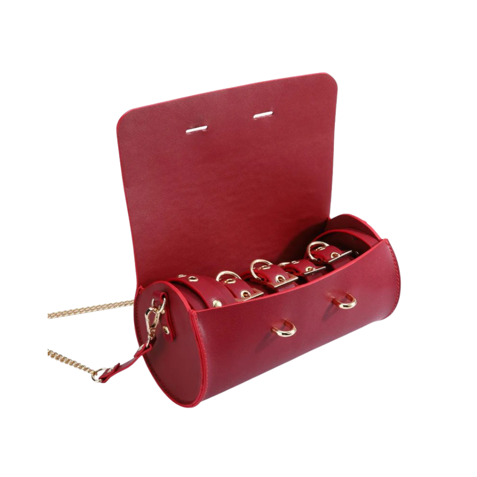 A red Luxe Bondage purse opened to show the contents.