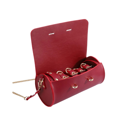 A red Luxe Bondage purse opened to show the contents.