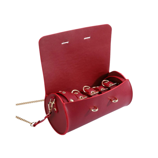 A red Luxe Bondage purse opened to show the contents.