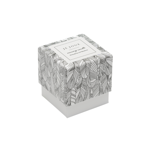 A black and white box containing a massage candle by Je Joue.