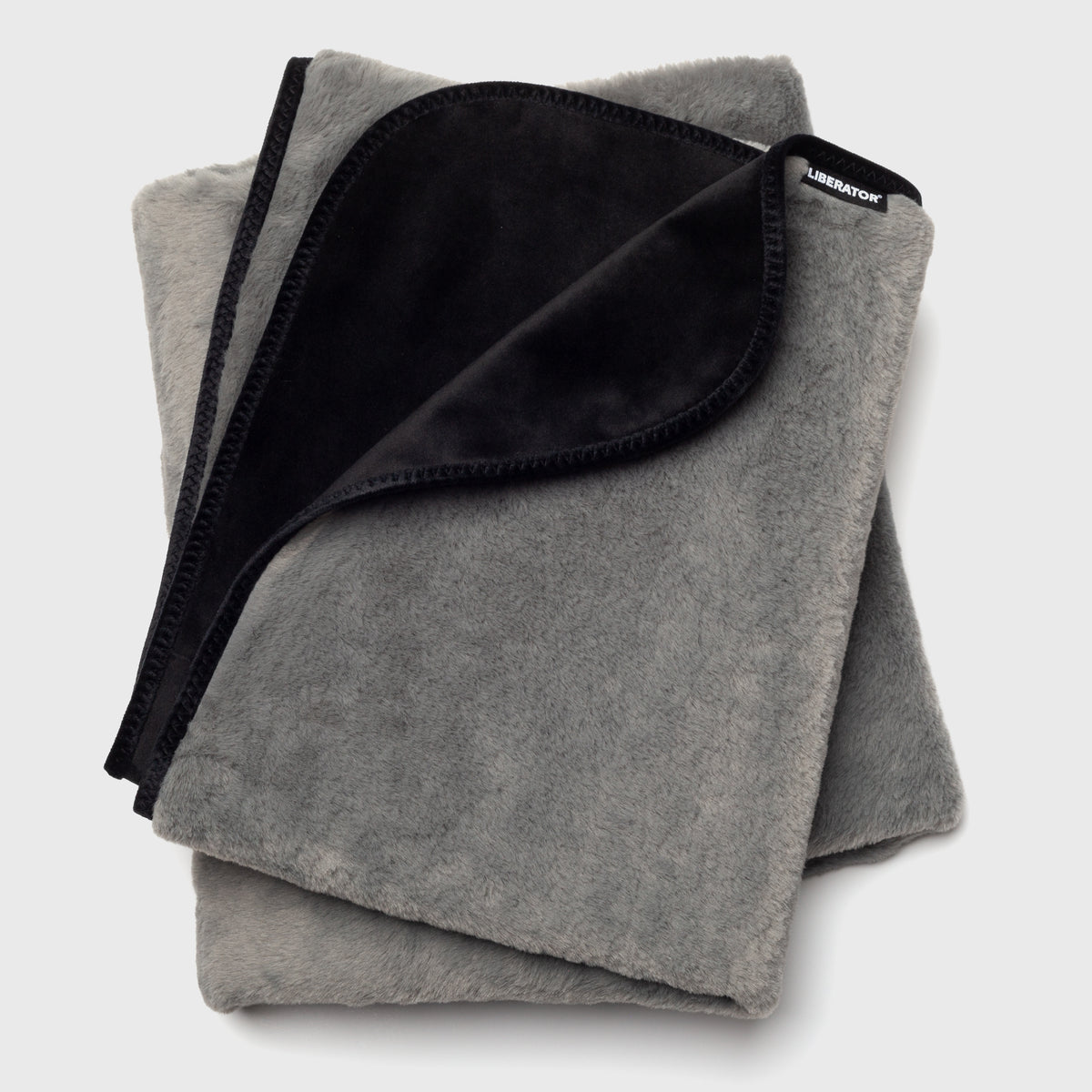 A grey Fascinator splashproof blanket showing what could come in the Merry & Wild Box.