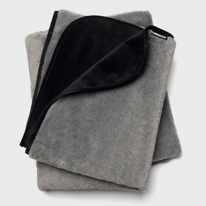 A grey Fascinator splashproof blanket showing what could come in the Merry & Wild Box.
