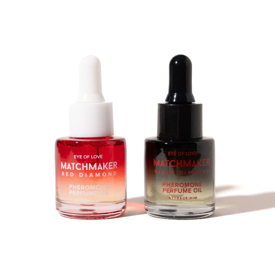 A red and white dropper bottle and a balck and white dropper bottle of Pheromone Perfume Oil Matchmaker Red and Black Diamond by Eye of Love for Attract Her and Attract Him against a white background.