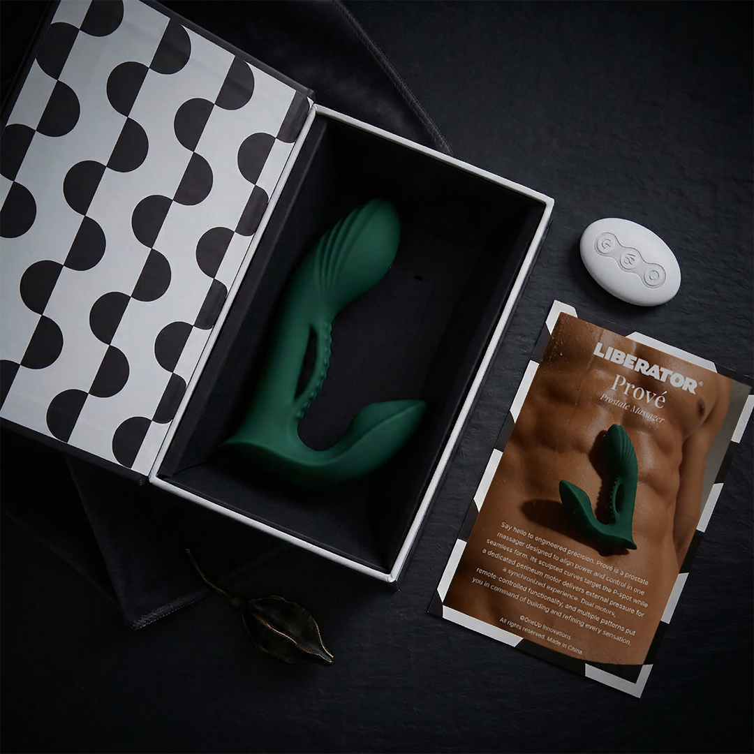 A green Prove Prostate Vibrator with remote by Liberator in the box showing contents.