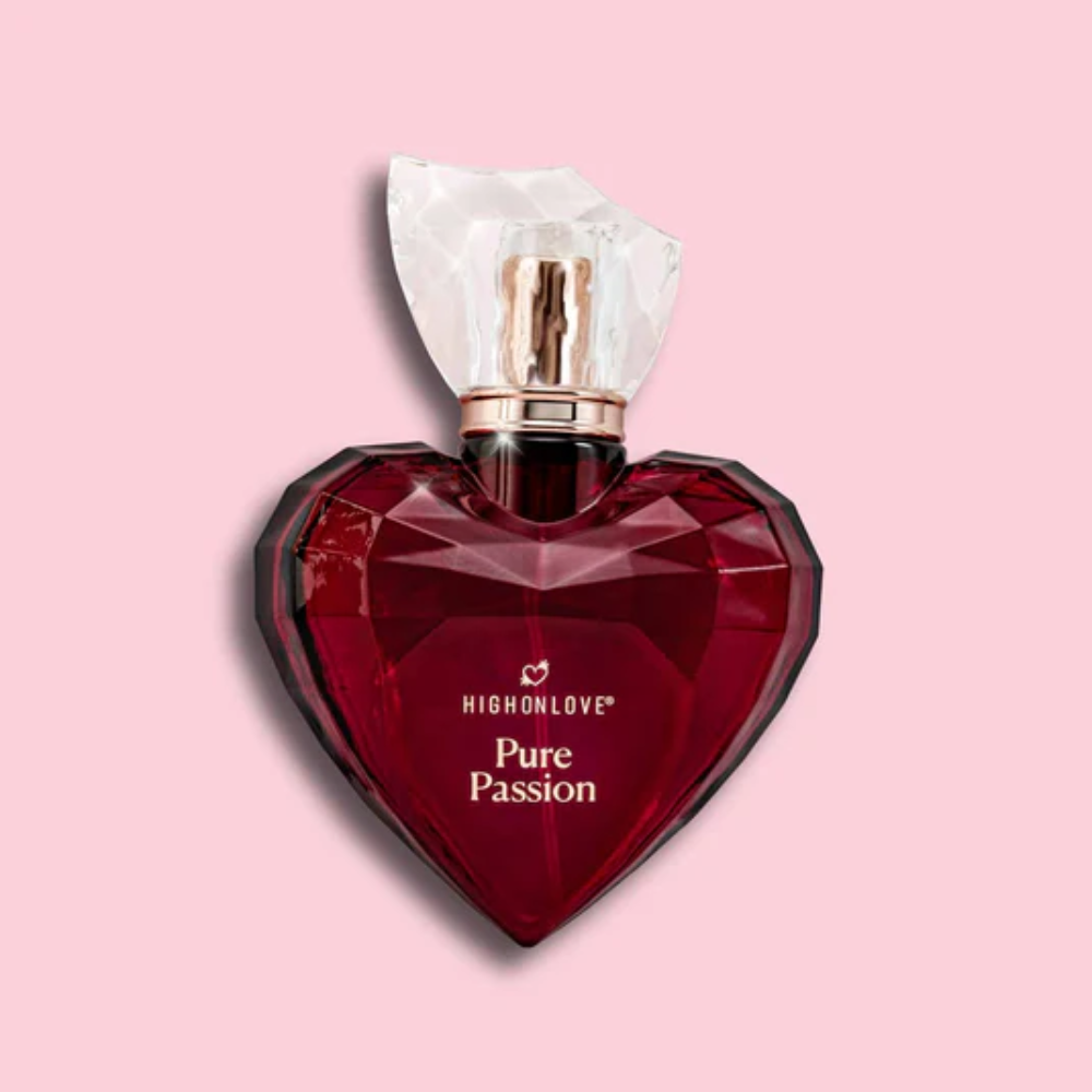 Heart-shaped red perfume bottle with High On Love and 'Pure Passion' on a pink background