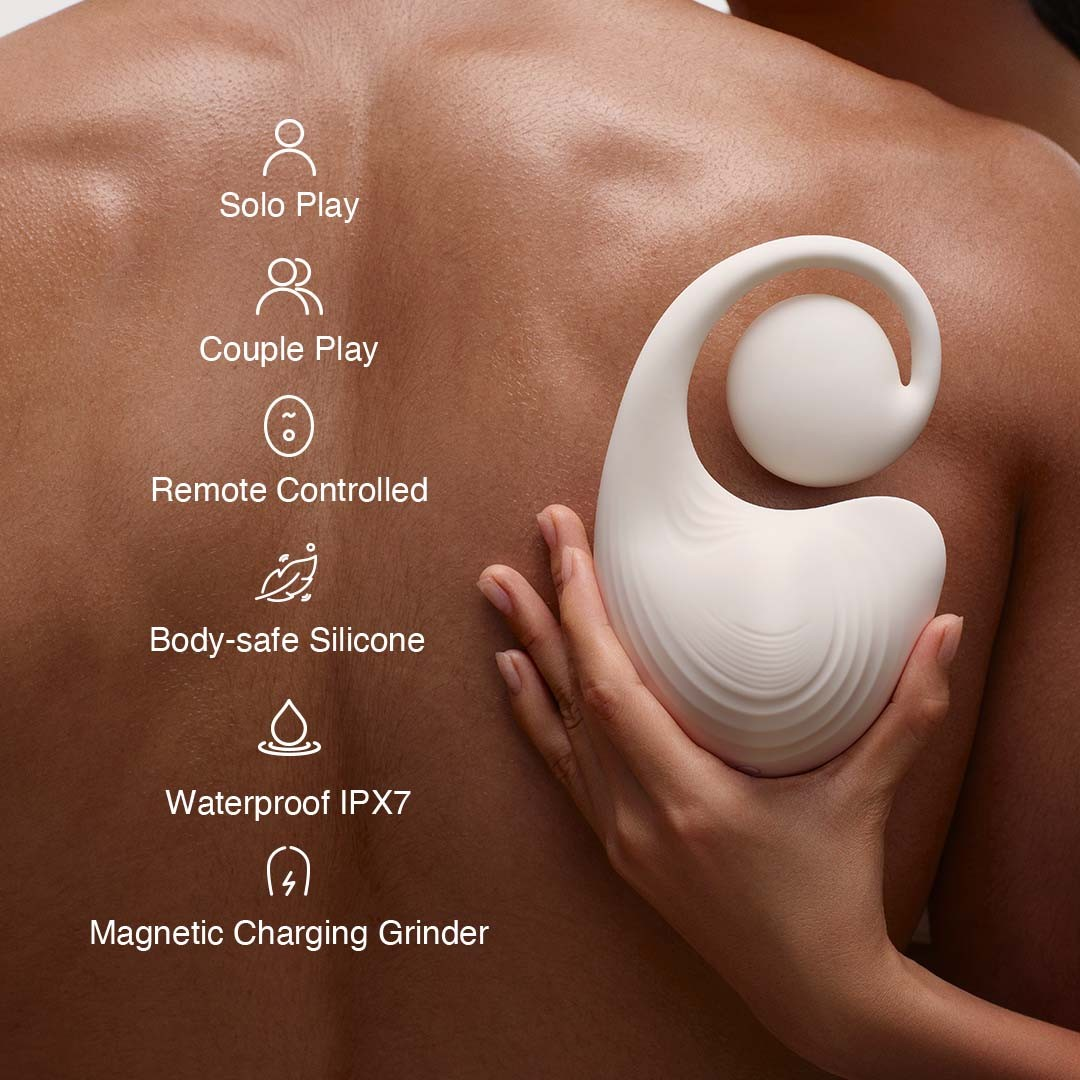 White handheld massager being held against a person's back with feature icons displayed.