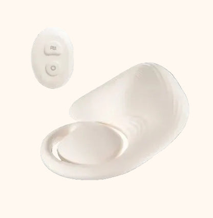 White grinder pad with a remote control on a white background
