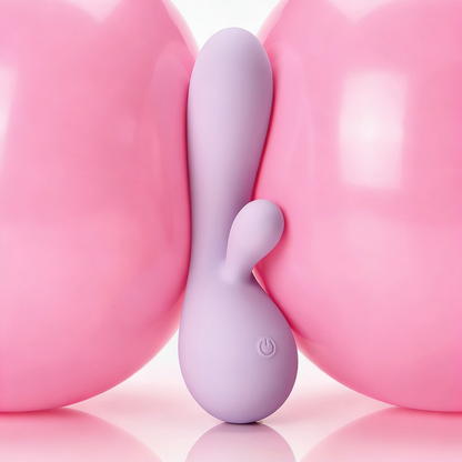 A pink Rya rabbit massager vibrator sitting between two pink balloons.