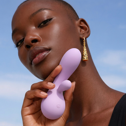 A lady holding a pink Rya rabbit massager vibrator.