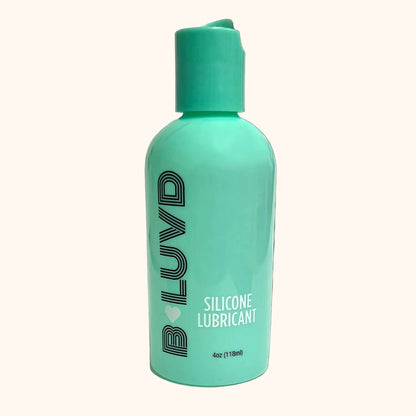 Turquoise bottle of BLUVD silicone lubricant on a white background