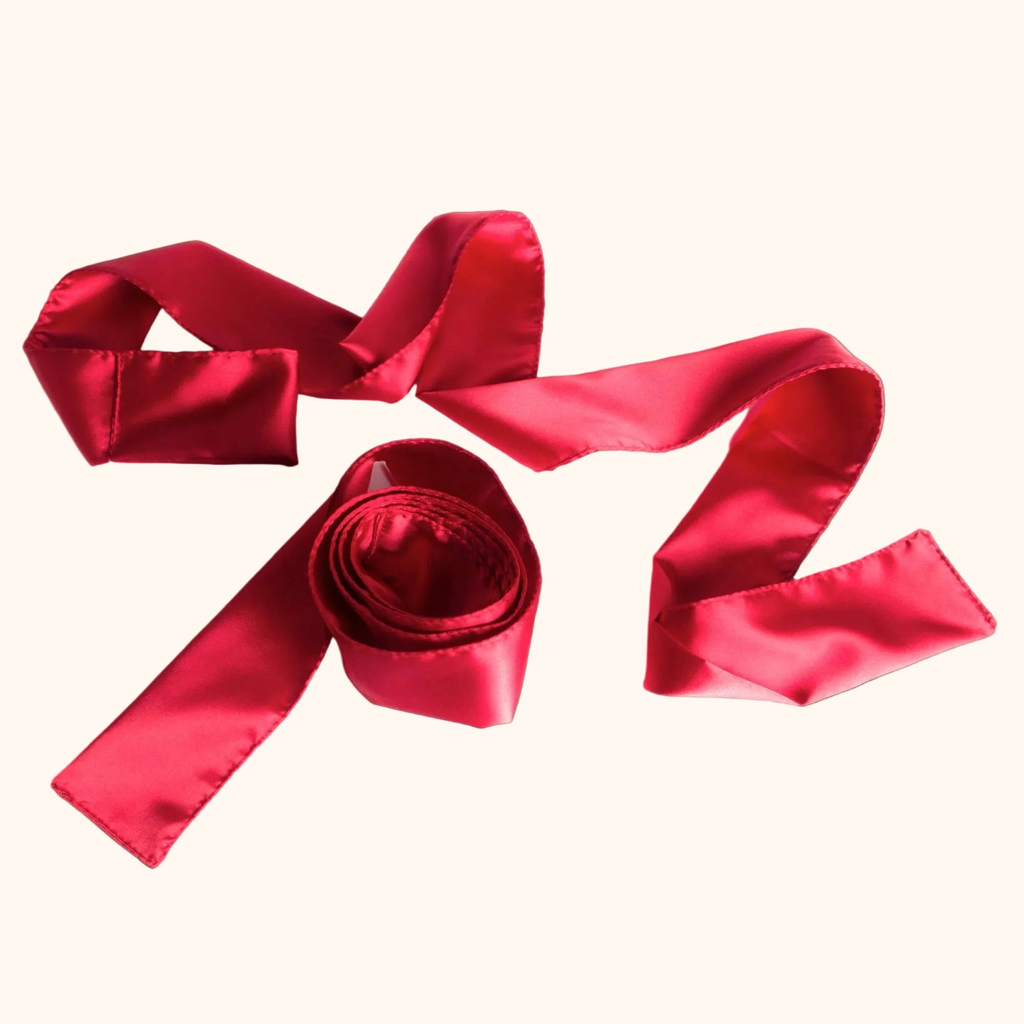Two red Silky Tie-Ups by Liberator against a white background.