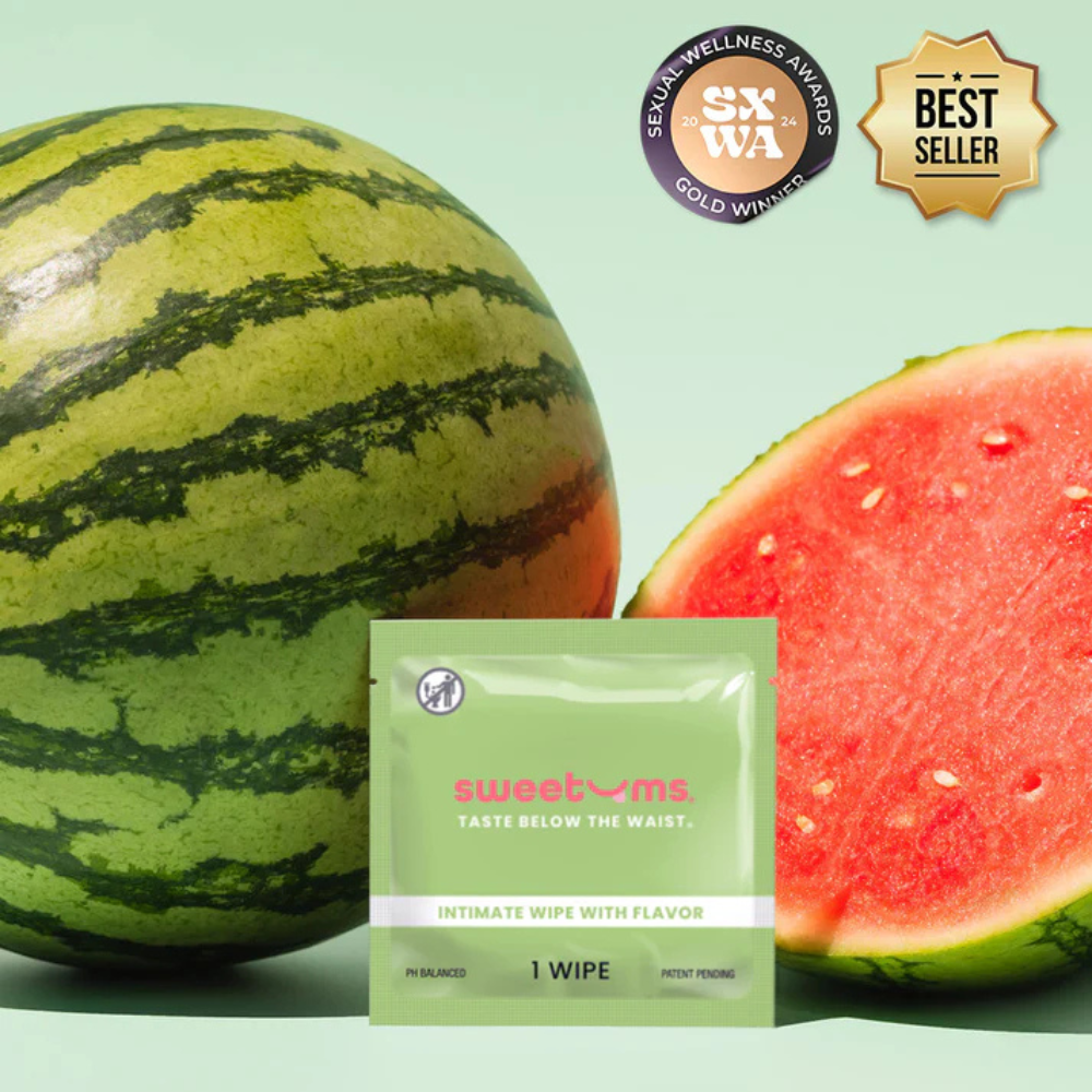An  individual package of watermelon flavored intimate wipe for her by Sweet Ums sitting next to a watermelon.