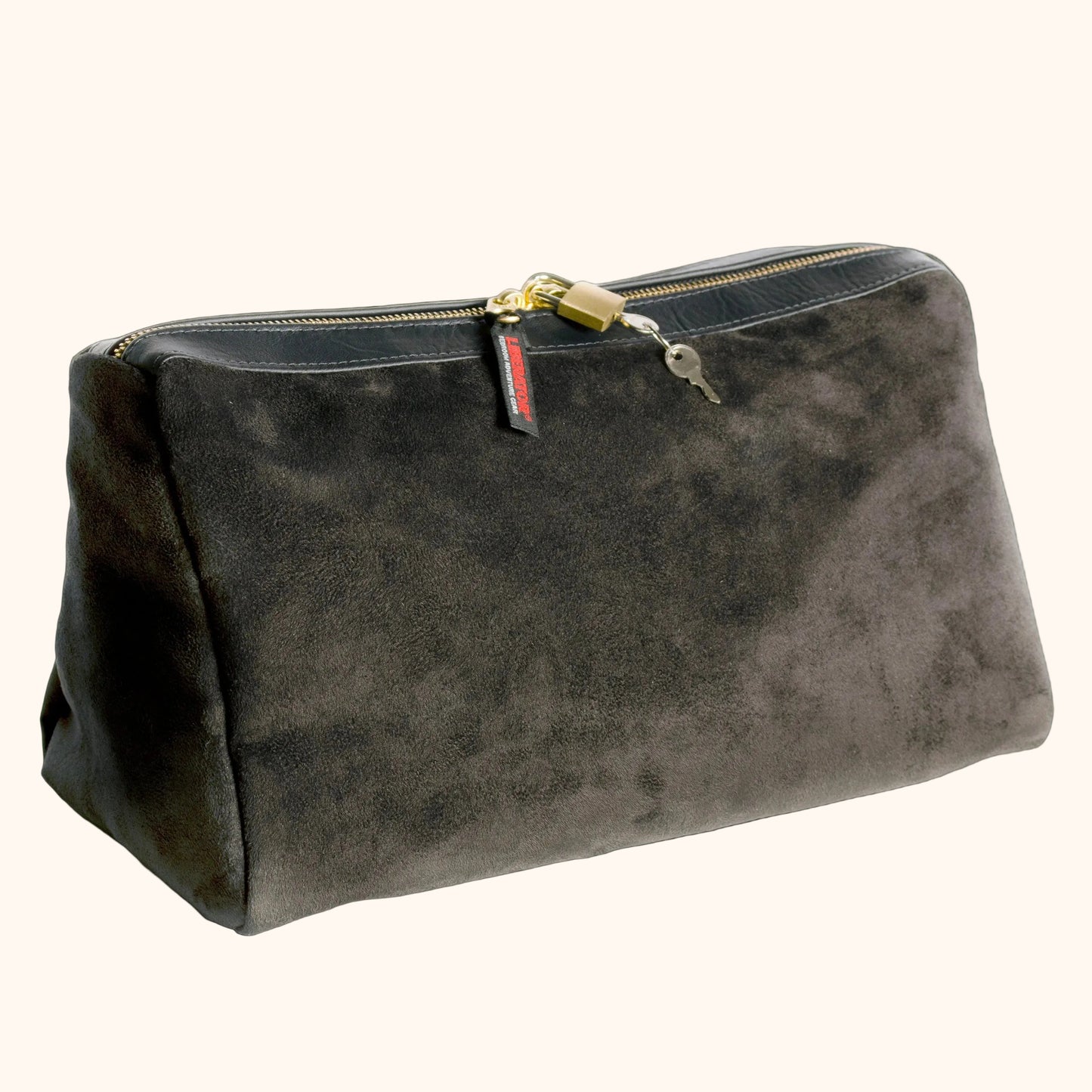 A black Tallulah Locking Toy Bag by Liberator with key and lock against a white background.