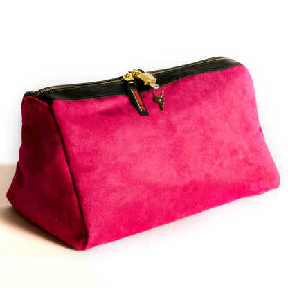 A fushia Tallulah Locking Toy Bag by Liberator with key and lock against a white background.