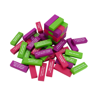 Colorful blocks of Tower of Pleasure in a pile with sexy commands on them.