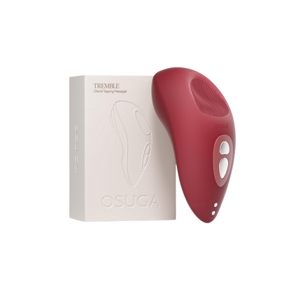 A red Tremble clitoral vibrator by Liberator sitting next to the box.