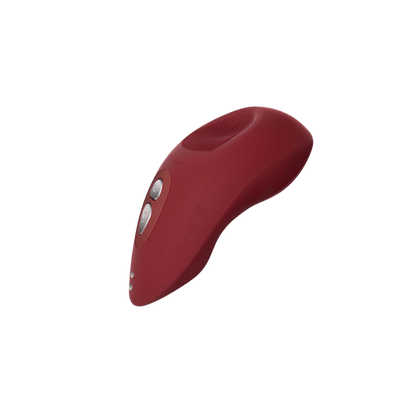 A red Tremble clitoral vibrator by Liberator.