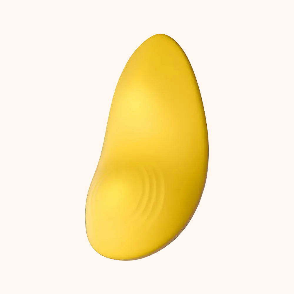A yellow Tremble clitoral vibrator by Liberator against a white background.