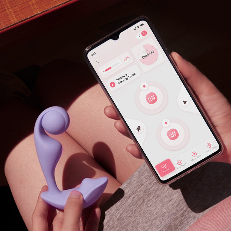 Someone holding Purple Trill vibrator next to a phone showing it's app controlled.