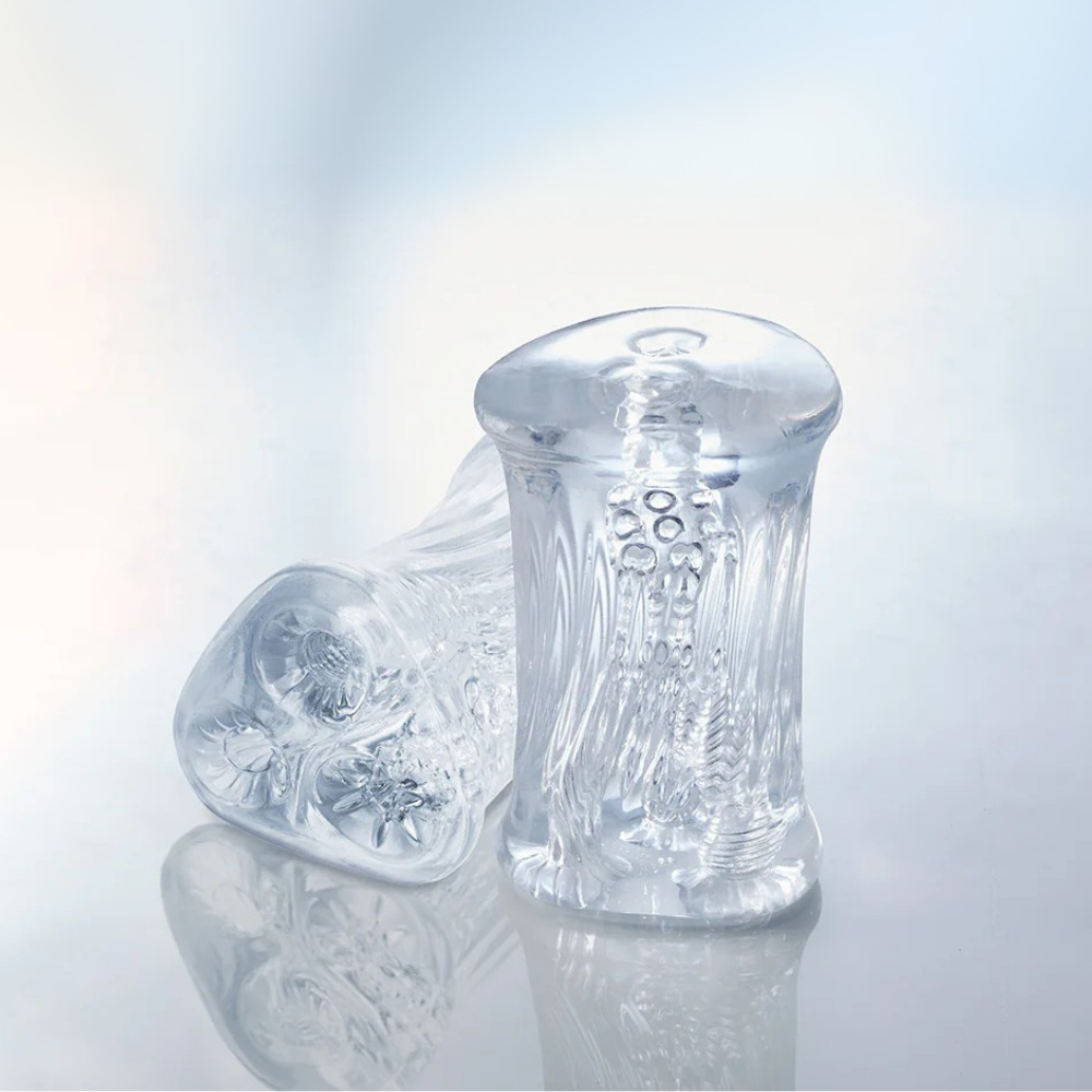 Two clear Cyclone Triple Chamber Strokers showing the side and top views of the chambers.