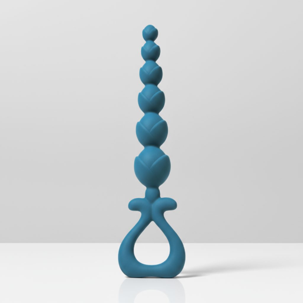 Blue silicone anal beads on a white table