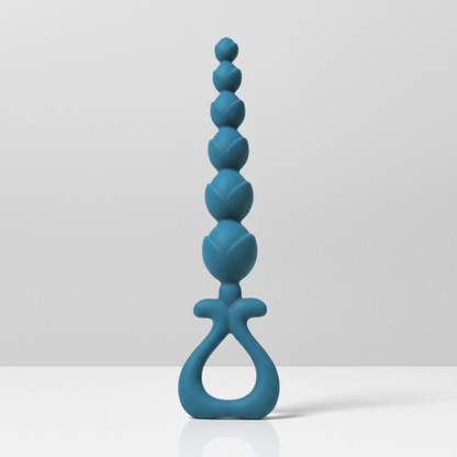 Blue silicone anal beads on a white table