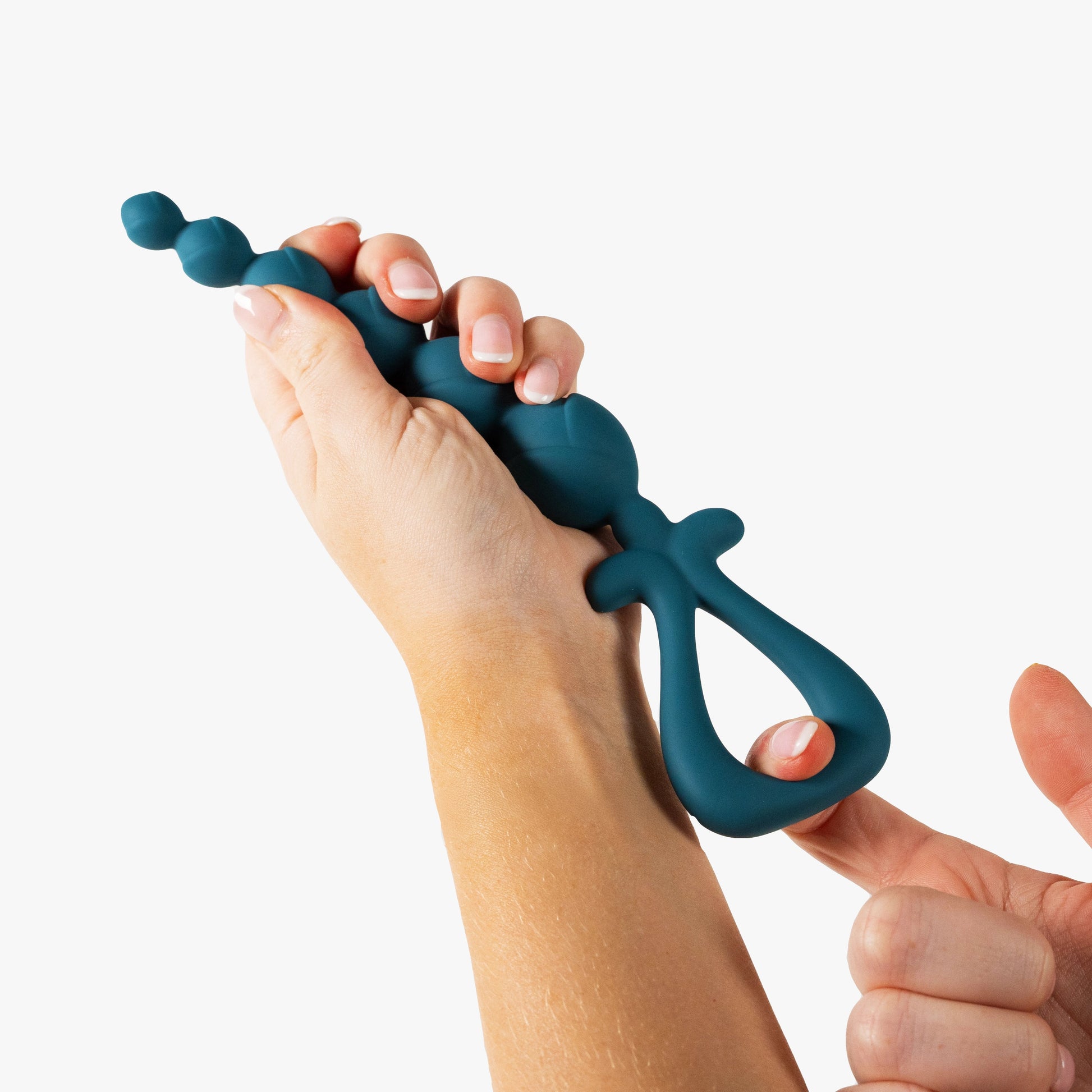 Teal blue anal beads held by a person on a white background