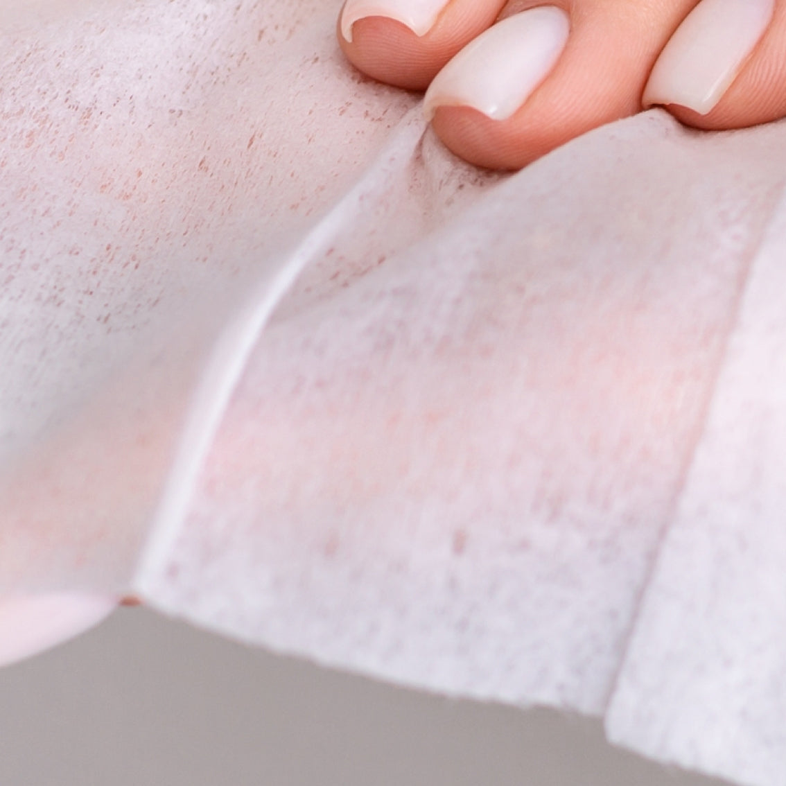 A hand holding a Beaver Butter Fresh Vaginal Wipe by ECN.