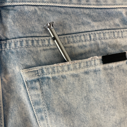 A silver Vesper mini in a jean pocket.