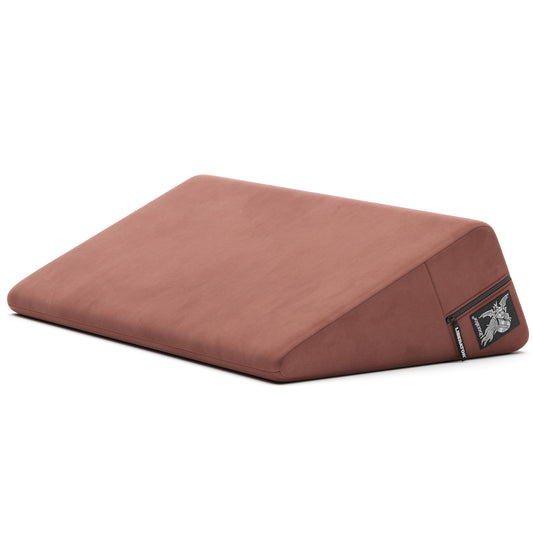 A mauve Wedge, Bedroom Furniture by Liberator against a white bedroom.