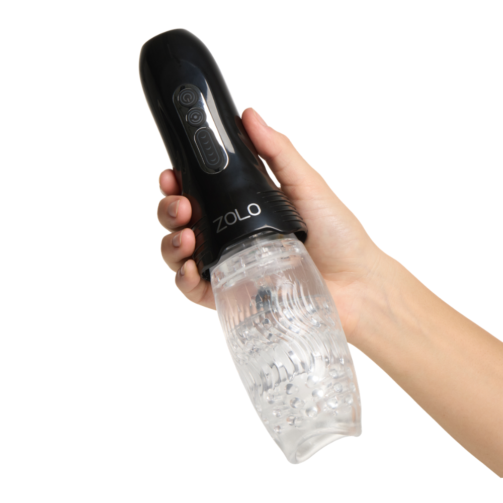 A hand holding a black Zolo Original Gwak Gwak Masturbator with a clear sleeve.