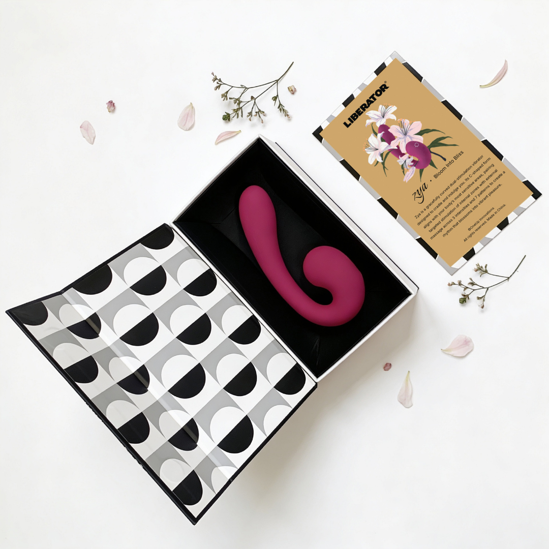 The box containing a purple Zya Vibrator next to the pamphlet on a white background.