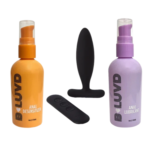 Two bottles of LUVD products (orange and purple) with a black butt plug and remote control on a white background.