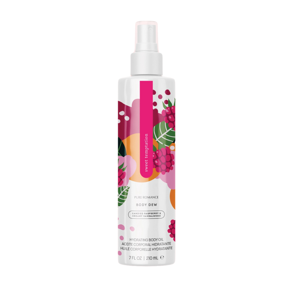 Lustra Hydrating Body Oil in Sweet Temptation by Pure Romance, featuring a colorful abstract label and spray nozzle, displayed on a glass shower shelf.