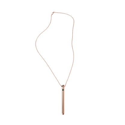 Rose gold necklace with a cylindrical pendant on a white background